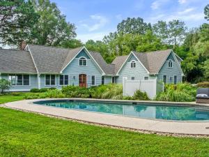 a house with a swimming pool in the yard at Blue Herons Villa in Royal Oak