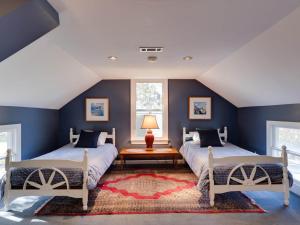 two beds in a room with blue walls at Captains Cove in Saint Michaels +66 photos