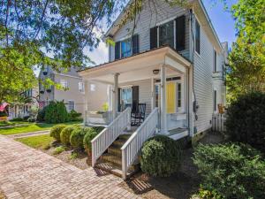 a white house with a porch and a staircase at Eventide of Oxford in Oxford