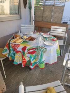 a table with a colorful table cloth with food on it at La maison des Cigognes in Hésingue