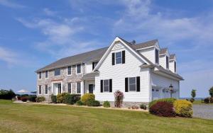 a white house with a gambrel roof at The Birds Nest in Madison