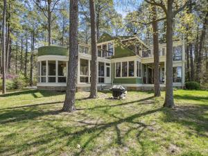 a large house with trees in front of it at The Water House in Saint Michaels