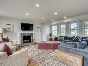a living room with two couches and a fireplace at Tranquil Waters in Tilghman