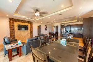 a dining room and living room with a table and chairs at 5 BEDROOM BEACHFRONT CONDO - 2nd Floor in South Padre Island