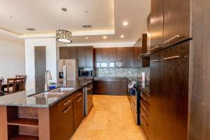 a kitchen with wooden cabinets and a counter top at 5 BEDROOM BEACHFRONT CONDO - 2nd Floor in South Padre Island