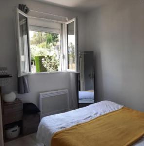 a bedroom with a bed and a large window at Les 3 Poneytes in Gez