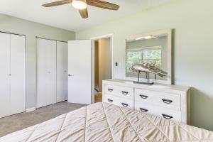a bedroom with a bed with a dresser and a mirror at 2 Mi to State Park Dog-Friendly Niceville Home in Niceville +16 photos