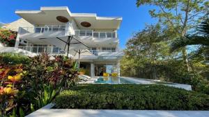 a white house with a swimming pool in front of it at Casa Blanca #1 Beautiful modern beach house in Sámara