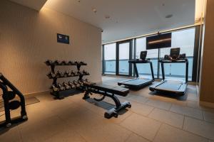a gym with cardio equipment in a building at Gracious 1BR in The Crest, Sobha Hartland in Dubai