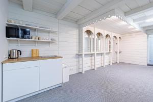 a kitchen with white cabinets and a counter in a room at STAY Kaunas city center in Kaunas