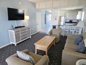 a living room with a couch and a table at Surf Side Hotel in Nags Head