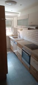 a kitchen with a sink and a stove top oven at 2-Zimmer Wohnung mit Küche und Terrasse in Geislingen an der Steige