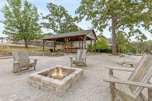 a fire pit with two chairs and a gazebo at Lake House - Lake Views in Kimberling City