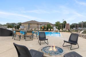 a patio with chairs and a table and a pool at Lake House - Lake Views in Kimberling City