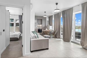 a living room with a couch and a bed and a table at SIA in Odyssey Pool & Spa Resort in Năvodari