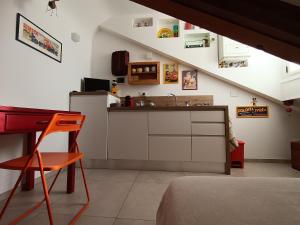 a kitchen with a sink and a desk in a room at La Mansarda delle Mongolfiere in Turin
