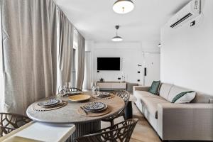 a living room with a table and a couch at SIA in Odyssey Pool & Spa Resort in Năvodari +56 photos
