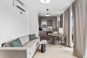 a living room with a couch and a table at SIA in Odyssey Pool & Spa Resort in Năvodari