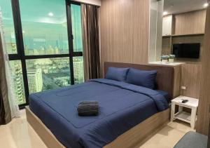 Ένα ή περισσότερα κρεβάτια σε δωμάτιο στο Dusit Grand Condo View Jomtien