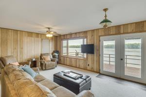a person laying on a couch in a living room at Scenic Views and Yard Mississippi River Retreat! in Fulton