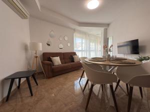 a living room with a table and a couch at LAttic Reserva BiosferaTerres de lEbre in Sant Carles de la Ràpita