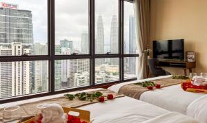 a hotel room with two beds and a large window at TM Persiaran Stonor KLCC - MK HOME in Kuala Lumpur +150 photos