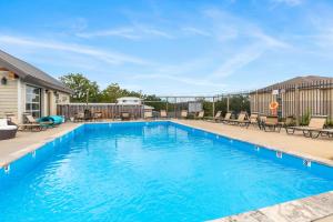 a swimming pool with blue water and patio furniture at The Harbor -Lake Front Home- Boat slips available in Kimberling City