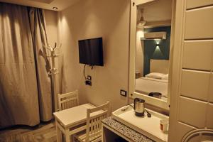 a small room with a small table and a mirror at Town Hotel- Hurghada in Hurghada +29 photos