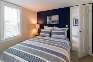 a bedroom with a bed with two pillows at Charming Beachside Bungalow in Truro
