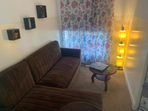 a living room with a couch and a table at Brise de Mer Apartment 3 Bedrooms in Djibouti