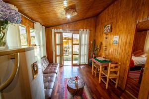 a room with a bedroom and a bed and a table at Eco Lodge Cabañas con Piscina in Urubamba
