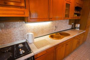 a kitchen counter with a sink and a stove at Apartment Miranda in Slatine +14 photos