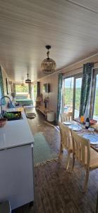 a kitchen and living room with a table and chairs at Green Discovery's Birds' Nests in Henrietta