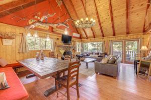a dining room and living room with a wooden ceiling at Game Room and 2 Decks Walkable Lake Arrowhead Cabin in Lake Arrowhead