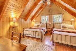 a bedroom with two beds and a wooden ceiling at Game Room and 2 Decks Walkable Lake Arrowhead Cabin in Lake Arrowhead
