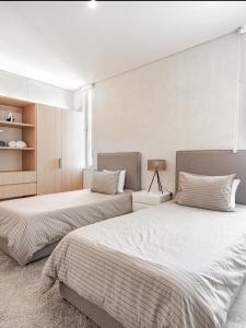 a bedroom with two beds and a window at Leu boutique condos in Cancún