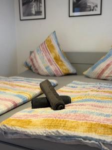 a bed with a brown towel on top of it at Appartement in MG City Self- Check-in in Mönchengladbach