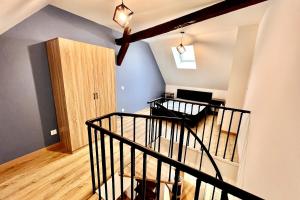 a room with a staircase leading to a living room at Luxury Duplex Auxonne Center in Auxonne +1 photo