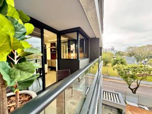 a balcony with a view of a house at Diamond Batel - Apartamentos by UROOMS in Curitiba