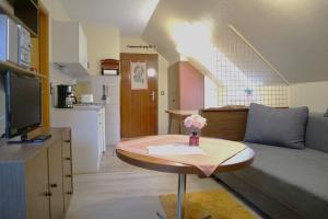 a small living room with a table and a couch at Birkenstübchen in Lautenthal
