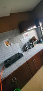 a kitchen with a counter top with a sink at 2 bedroom service apartment in Ibadan