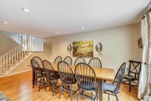 a dining room with a wooden table and chairs at Spruce Pond Haven in Stowe +20 photos