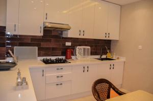a kitchen with white cabinets and a stove at Perfect Stop in Midelt in Midelt