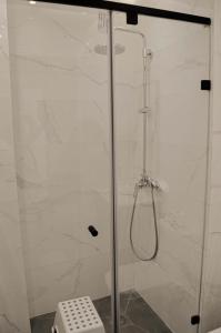 a shower with a glass door in a bathroom at Perfect Stop in Midelt in Midelt