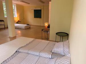 a bedroom with a bed and two chairs in a room at Meirānu muiža in Meirāni +12 photos