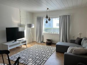 a living room with a couch and a flat screen tv at Lemminkäinen in Kokkola