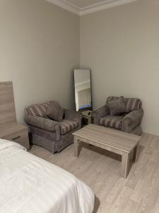 a living room with two couches and a coffee table at شقق رحابة المكان للشقق المفروشه in Al Kharj