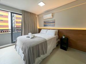 Postel nebo postele na pokoji v ubytování Quartz Intermares Flat Completinho 150m Praia + 17 fotografií