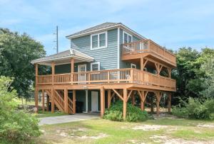 a large house with a wrap around deck at Sandpiper Trace - K1444 in Kill Devil Hills