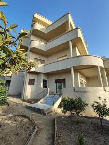 a large building with stairs in front of it at Apartment in Villa - Tangier in Tangier